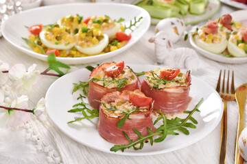 Easter breakfast with vegetable salad wrapped in parma ham and deviled eggs