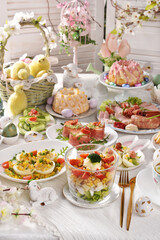 Easter breakfast with vegetable salads, cold cuts and deviled eggs