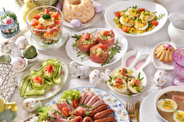 Fototapeta na wymiar Easter breakfast with vegetable salads, cold cuts and deviled eggs