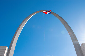 Dominican Flag with arch in park