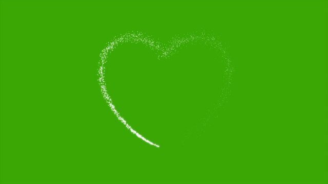 Heart shape formed by glitter particles on green screen background