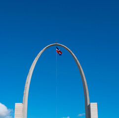 flag in sky with arch, Dominican Republic, plaza de la Bandera.