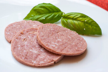 slices of salami with green albahaca
