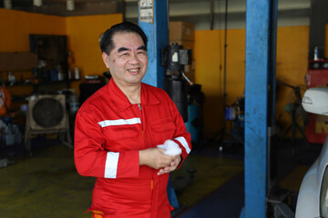 Standing In Front Of Workshop. Car Repairman Auto Mechanic Working In Garage With Automobile. Repair service. Selective Focus.