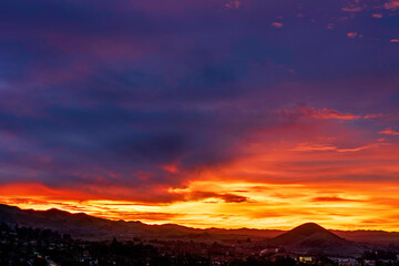 sunrise, sunset, over city, silhouetted with hill