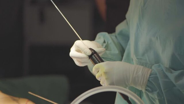 Plastic surgeon manipulating a suction catheter for fat removal on argentina.