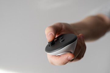 Close-up of the VR/AR headset controller on a gray background. Controller in hand. Pressing buttons and using the joystick.