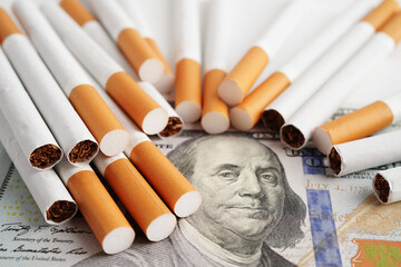 Cigarette on US dollar banknotes, cost, trading, marketing and production, No smoking concept. - obrazy, fototapety, plakaty