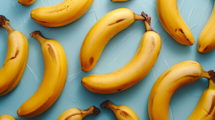 Flat lay of bananas on light blue background. From top view.