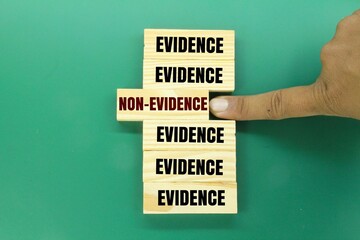 wooden arrangement with the words evidence and non-evidence. concept of proof