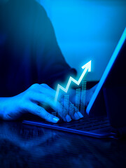 Rise up glow arrow, volatility index chart on digital online business graph steps while businessman work with laptop, blue tone background. Business growth, profit, trading, goal and success concepts. - obrazy, fototapety, plakaty
