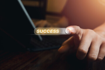 Word "SUCCESS" on virtual screen with 3d button or tab switch with target icon, pressing by person who working with laptop computer, dark background. Business success in career or education concepts.