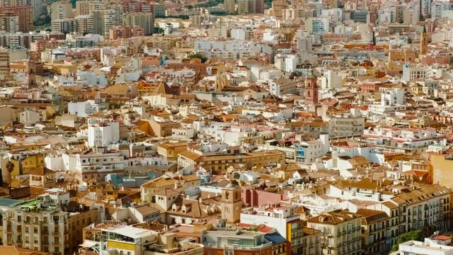 Establishing shot of Malaga, Andalucia, Spain, capturing the sprawling residential district with a backdrop of stunning mountains