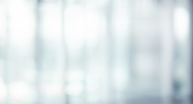 Blurred abstract glass wall from building in city town background.