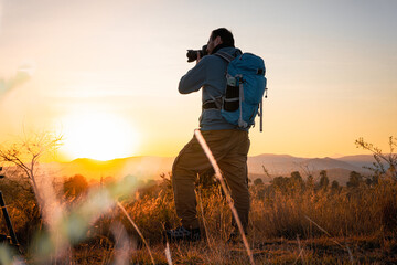  photographer, alone and contemplative. With camera in hand and backpack on his back, adventurer concept, local travel