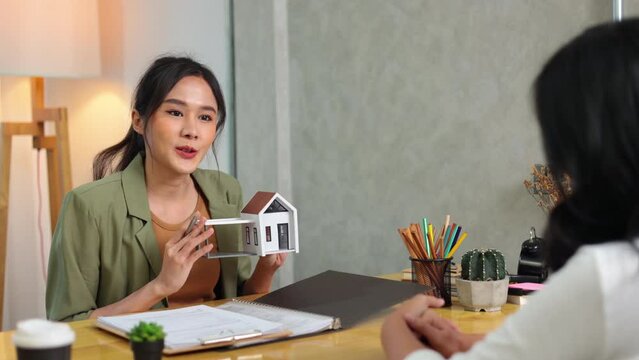 home salesperson explaining new home model to customer thinking of buying home. Professional real estate agent or insurance sales. Mortgage property insurance. New home, successful deal meeting
