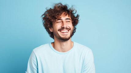 Happy smiling young adult man on a solid background