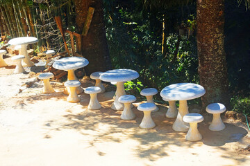Cement table sets form mushroom pattern in garden on hill