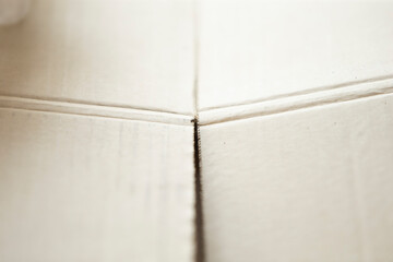 Close up of white paper board texture useful as a background or wallpaper.