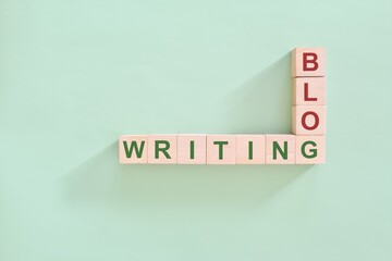 Blog writing concept. Crossword puzzle flat lay typography in green background.	