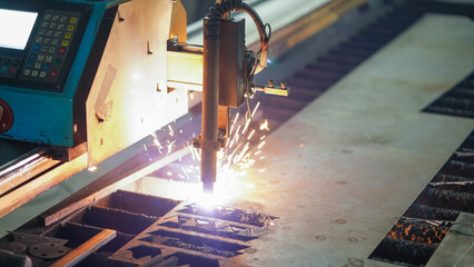 laser cutting machine working with sheet metal with sparks metalworking industrial manufacturing...