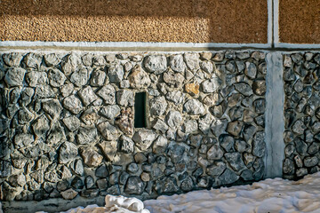 A fragment of the basement of the building on a winter day