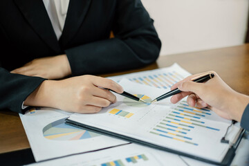 Two business leaders talk about charts, financial graphs showing results are analyzing and calculating planning strategies, business success building processes