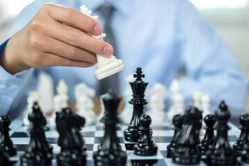 hand of businessmen moving chess in competition shows leadership, followers and business success...