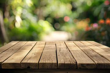 
A wooden table with no objects on it and a blurred outdoor garden background. The wooden table provides space for text and can be used for marketing promotions