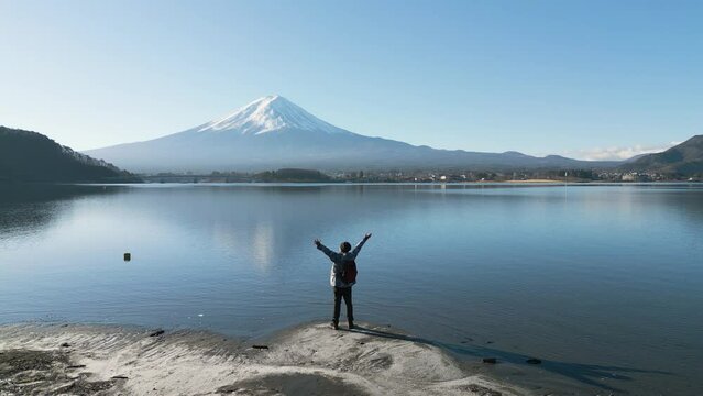Happy man enjoy outdoor lifestyle travel Japan on winter vacaton at Lake Kawaguchiko