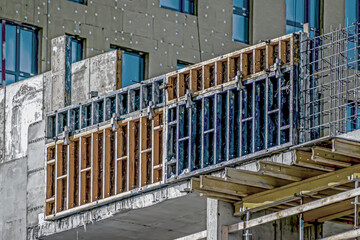 A fragment of the construction site of a multi-storey residential building on a winter day