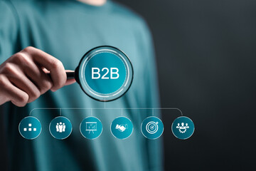 B2B marketing concept, Businessman with virtual B2B icons for professional business and commerce collaboration. business action plan strategy. business to business, e-commerce.