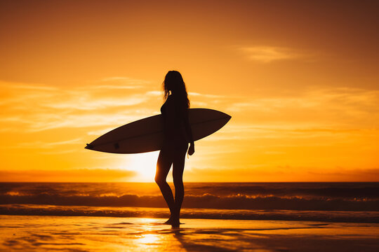 Silhouette of a Female Surfer with Board Watching Sunset on the Beach. Surfing Lifestyle and Summer Vibes Concept - Powered by Adobe