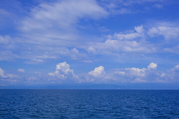 background for summer vacation concept. Nature of the beach and sea, summer with sunlight, sandy beach The sparkling sea water contrasts with the blue sky	