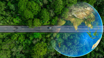 Aerial top view of green electric vehicle car driving over straight forest road, EV car electric...