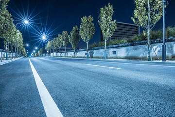 New asphalt road and cityscape at night