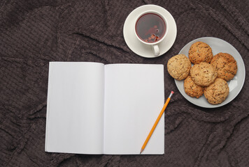 Blank notebook or magazine and breakfast in bed.