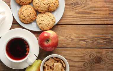 cereal cookies with Cup of tea and fruits on the table