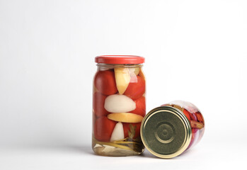 Pickled Canned tomatoes in glass jars on white background
