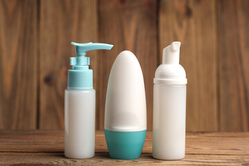 Aetipirspirant, bottle of cream and liquid soap with dispenser on wooden background