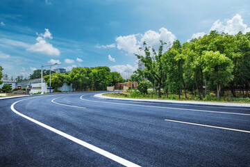 Empty asphalt road and cityscape background