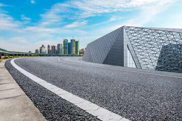 Fototapeta premium Empty asphalt road and city skyline background