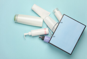 Blue cardboard bag with cosmetics on a blue background