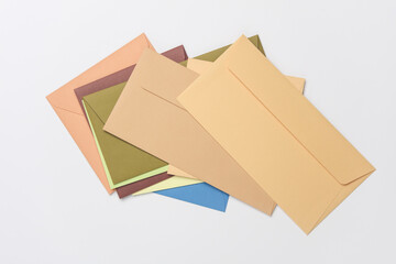 Stack of colored envelopes on white background