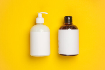 Bottle of liquid soap on a yellow background
