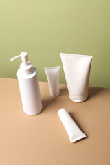 Cosmetics Bottles on green beige background