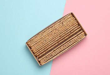 Crispy bread on pink blue background. Top view