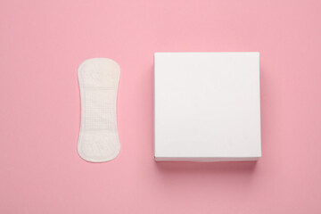 Box with sanitary pads on pink background. Feminine hygiene