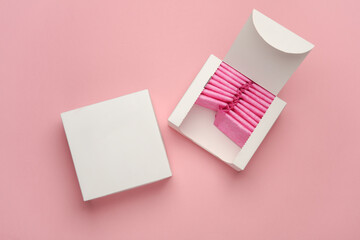 Box with sanitary pads on pink background. Feminine hygiene - obrazy, fototapety, plakaty