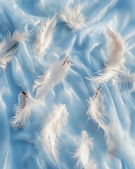 Delicate white feathers falling on a silky blue fabric for a serene and soft concept